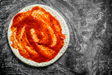 Poster - Raw pizza. Dough with tomato paste.