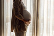 © ikostudio - Pregnant woman at the window