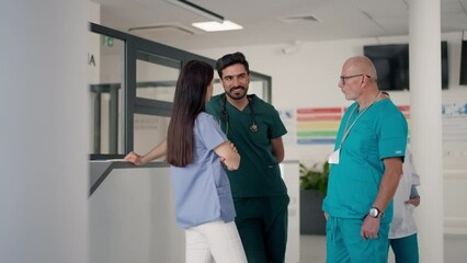 Poster - Medical staff discussing something at hospital corridor.