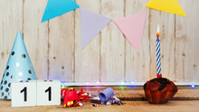 Festive Happy Birthday Background With Number Or Digit  11. Postcard With A Muffin And Burning Candles. Festive Copy Space Background.