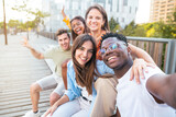 happy Multiracial group of friends making a selfie with phone in the university, focus on the girl - friendship, happiness and joyful concept. Cheerful students portrait
