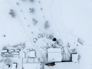 Canvas Print - Aerial view of town with snow covered houses. Roof tops with snow on residential buildings in Switzerland.