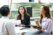 © offsuperphoto - businesswoman meeting and talking about work or project with colleague in the office