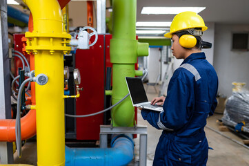 Wall Mural - Maintenance technician at a heating plant,Petrochemical workers supervise the operation of gas and oil pipelines in the factory,Engineers put hearing protector At room with many pipes