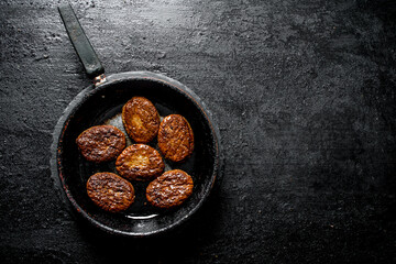 Poster - Cutlets in an old pan.