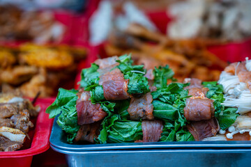 Wall Mural - Marinated meat with herbs on the counter of a street restaurant for grilling in mountain village Sapa, north Vietnam. Traditional asian food for tourist