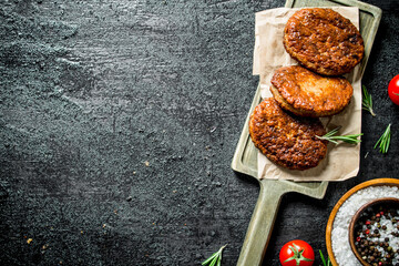 Poster - Cutlets on paper with spices in bowl.