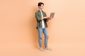 Poster - Full length cadre photo of young freelancer copywriter man wear trendy outfit online browsing netbook email isolated on beige color background