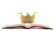 A Golden Crown on a Holy Bible on a White Background