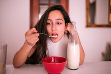 Teen Girl Eating Milk With Cereal
