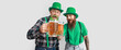 © Pixel-Shot - Bearded men with mugs of beer on light background. St. Patrick's Day celebration
