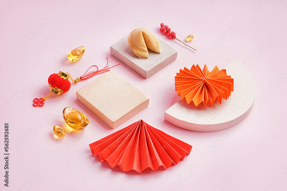 Fortune cookie, podiums and Chinese symbols on pink background