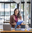 © David - young business Asian woman holding document file at workplace office