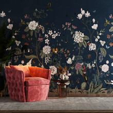 Modern Interior Living Room Background With Wallpaper Of Rose Branches, Plants, Birds And Butterflies In Dark Blue, Vintage Style, With Bean Chair, Table And Wall Lights - 3D Rendering