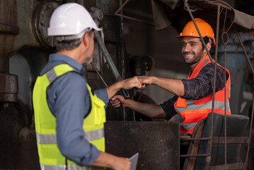 Worker at machine in factory, Metal industry worker at factory.