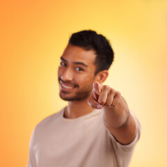 Sticker - Man, point and happy portrait of a person with a hand sign with orange studio background. Smile, isolated and model with blur mock up space and hands and finger gesture zoom smiling alone with beard