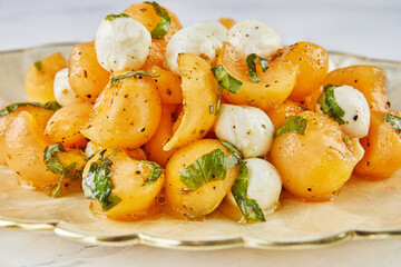 Canvas Print - Salad with melon mugs baby mozzarella and herbs on white marble