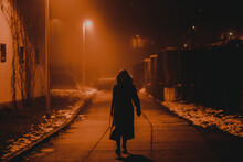 Silhouette Of A Young Woman In A Foggy Night Winter City