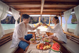 Fototapeta  - Asian couple lover travel and relax in they honeymoon trip on the wooded boat