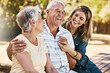 © Grady R/peopleimages.com - Woman, grandparents and hug for family summer vacation, holiday or break together in the outdoors. Happy grandma, grandpa and daughter with smile in joyful happiness, love or care for elderly parents