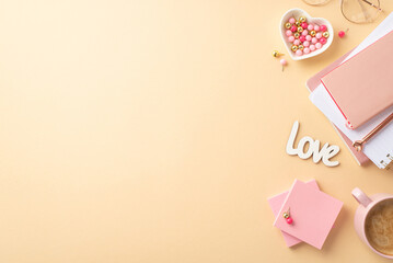 Valentine's Day concept. Top view photo of workplace copybooks heart shaped saucer pushpins glasses inscription love cup of coffee sticky note paper on isolated pastel beige background with copyspace