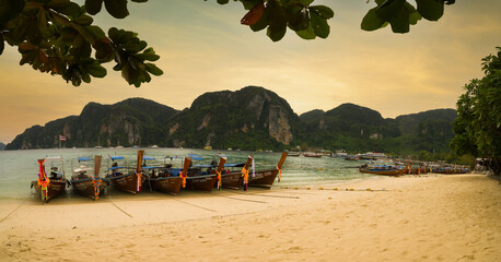 Wall Mural - The famous Ton Sai beach at sunset. Traditional tour boats on the beach and beautiful bay view. Krabi, Thailand 