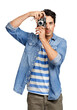 © peopleimages.com - A handsome young man taking a picture of you Isolated on a PNG background.