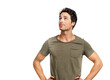 © peopleimages.com - A handsome young man standing with hands on his hips looking up Isolated on a PNG background.