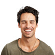 © peopleimages.com - A handsome young man smiling with his eyes closed Isolated on a PNG background.