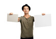 © peopleimages.com - A handsome young man holding up two placards Isolated on a PNG background.