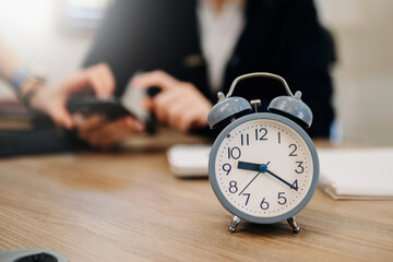 Wall Mural - alarm clock on the desk. business working in modern office building or home at night using laptop..