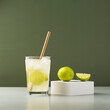 Summer refreshing lemonade drink or alcoholic cocktail with and lime. Citrus lemonade with lime, selective focus. Cold Mojito cocktail.