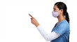 © peopleimages.com - Side shot of a young doctor wearing a surgical face mask and pointing to her right Isolated on a PNG background.