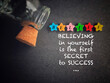 Inspirational and motivational quote of believing in yourself is the first secret to success. Text in vintage background. Stock photo.