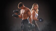 © Igor Link - smiling woman an man with dumbbell - successful fitness studio concept