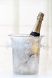 Bottle of Champagne in atransparent ice bucket