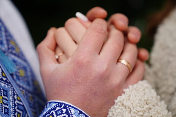 Wall Mural - Wedding rings in the hands of the bride and groom.
