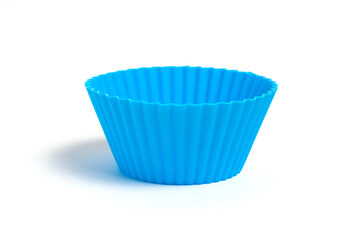 Wall Mural - Blue silicone mold for baking a cupcake on a white background