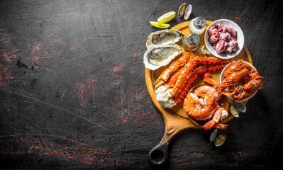 Wall Mural - Fresh seafood on a cutting Board with lime and spices.