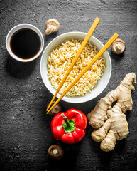 Poster - Instant noodles in bowl with bell pepper, ginger and soy sauce.