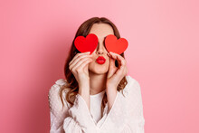 The Girl Closes Her Eyes With Paper Hearts And Sends An Air Kiss. Valentine's Day. Emotion Girl In Love