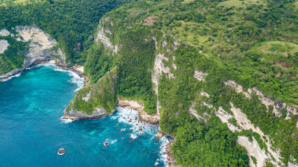 Wall Mural - Beautiful coastline aerial view from Saren Cliff Point. Clear water and rocks with cloudy sky. Nusa Penida, Indonesia.