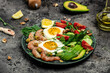 Ketogenic breakfast. Keto low carb shrimps, prawns, quail eggs, fresh salad, tomatoes, cucumbers and avocado on a light background. keto diet. Top view