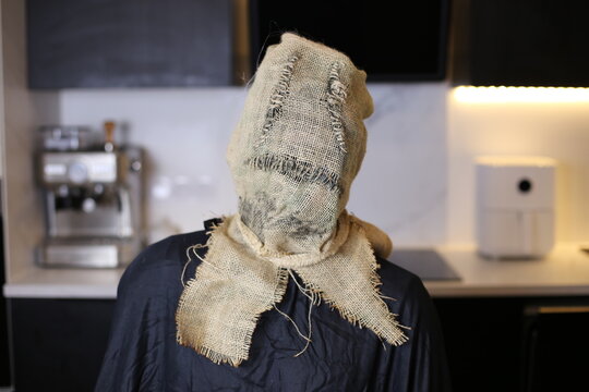 Spooky intruder wearing vintage scarecrow mask 