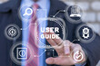 © wladimir1804 - Businessman using virtual touchscreen presses the inscription: USER GUIDE. Download user manual book.