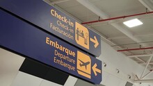 Airport Signage Indicating The Check-in Desks And Departure Area.