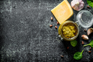 Canvas Print - Pesto sauce in a jar with Basil, garlic cloves and Parmesan.