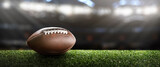 Fototapeta  - American football ball on the grass of a stadium