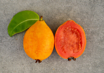 Wall Mural - Ripe guava fruit on a gray background. Psidium guajava.Tropical fruits,healthy food or diet concept. Selective focus.