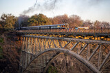 Fototapeta  - The Victoria Falls Steam Train on the Victoria Falls Bridge between Zimbabwe and Zambia, Africa